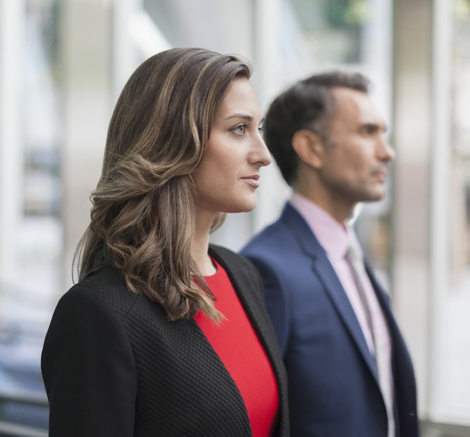 two office workers smiling at laptop